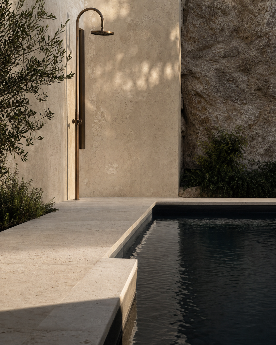 Limestone, water, and bronze details at an Aquaform pool